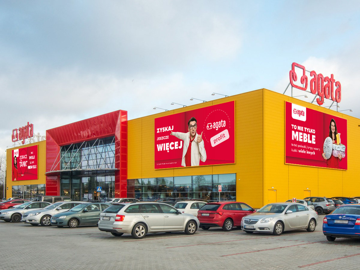 Wide-angle view of Agata's store exterior, highlighting the storefront and adjacent parking area for customer convenience.